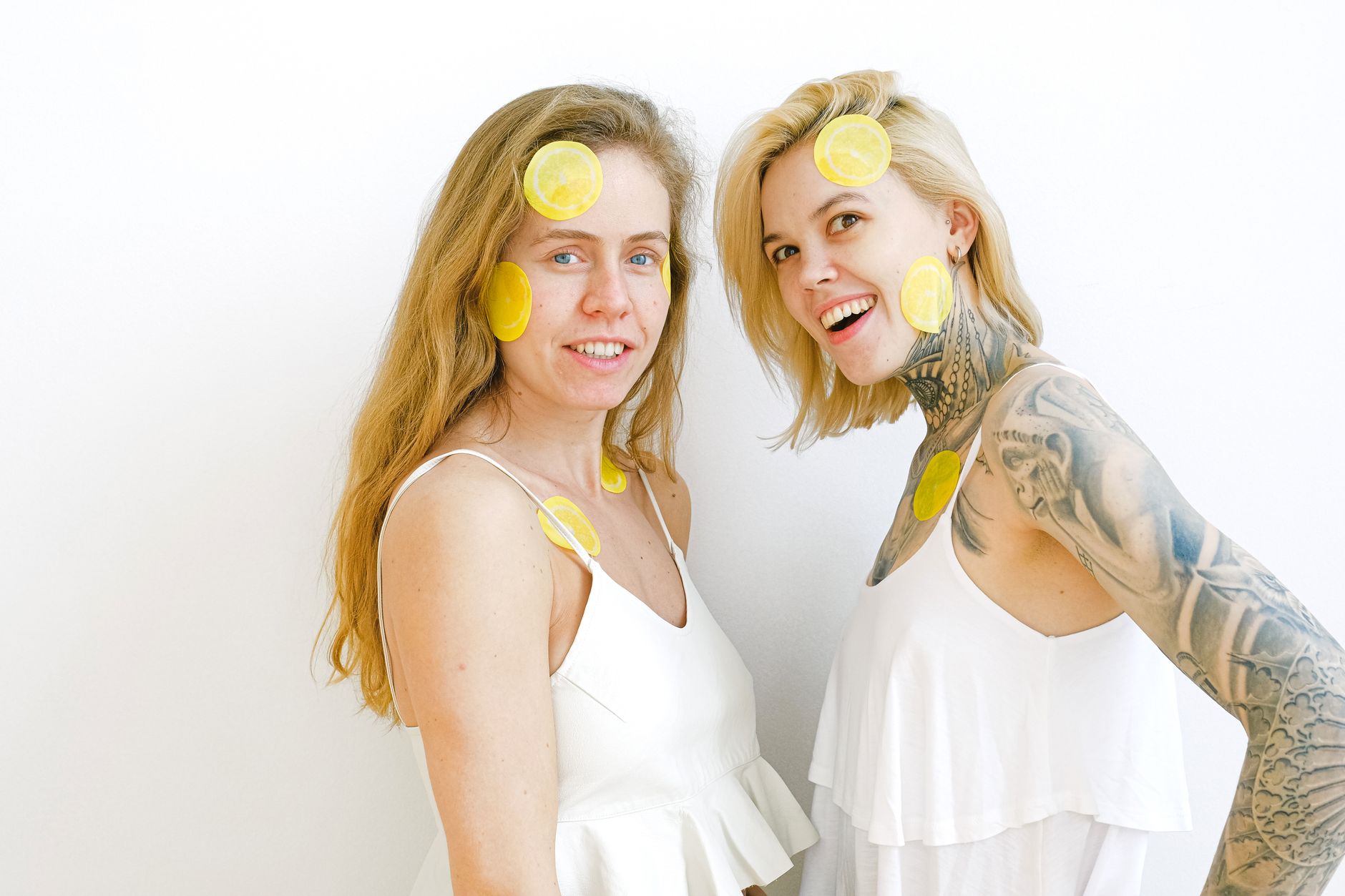 Hand holding a lemon vibrator against a minimalist backdrop, representing pleasure and sensation