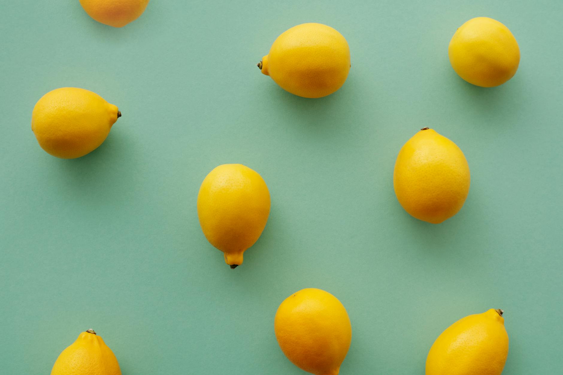 Bright yellow lemons arranged on a pastel green background, symbolizing freshness and renewal in mature relationships