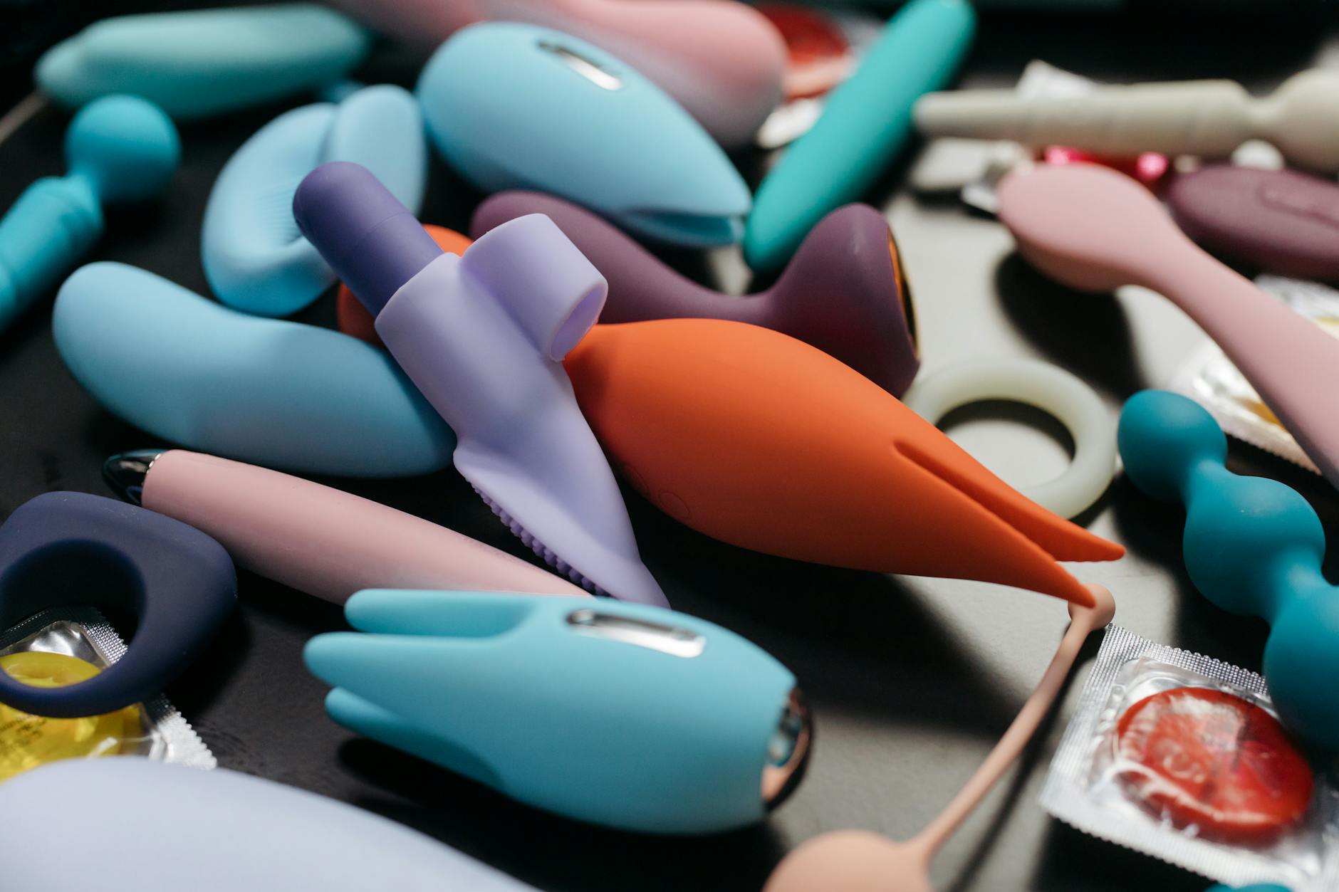 Close-up of colorful vibrators and intimate wellness products showcasing sensation options