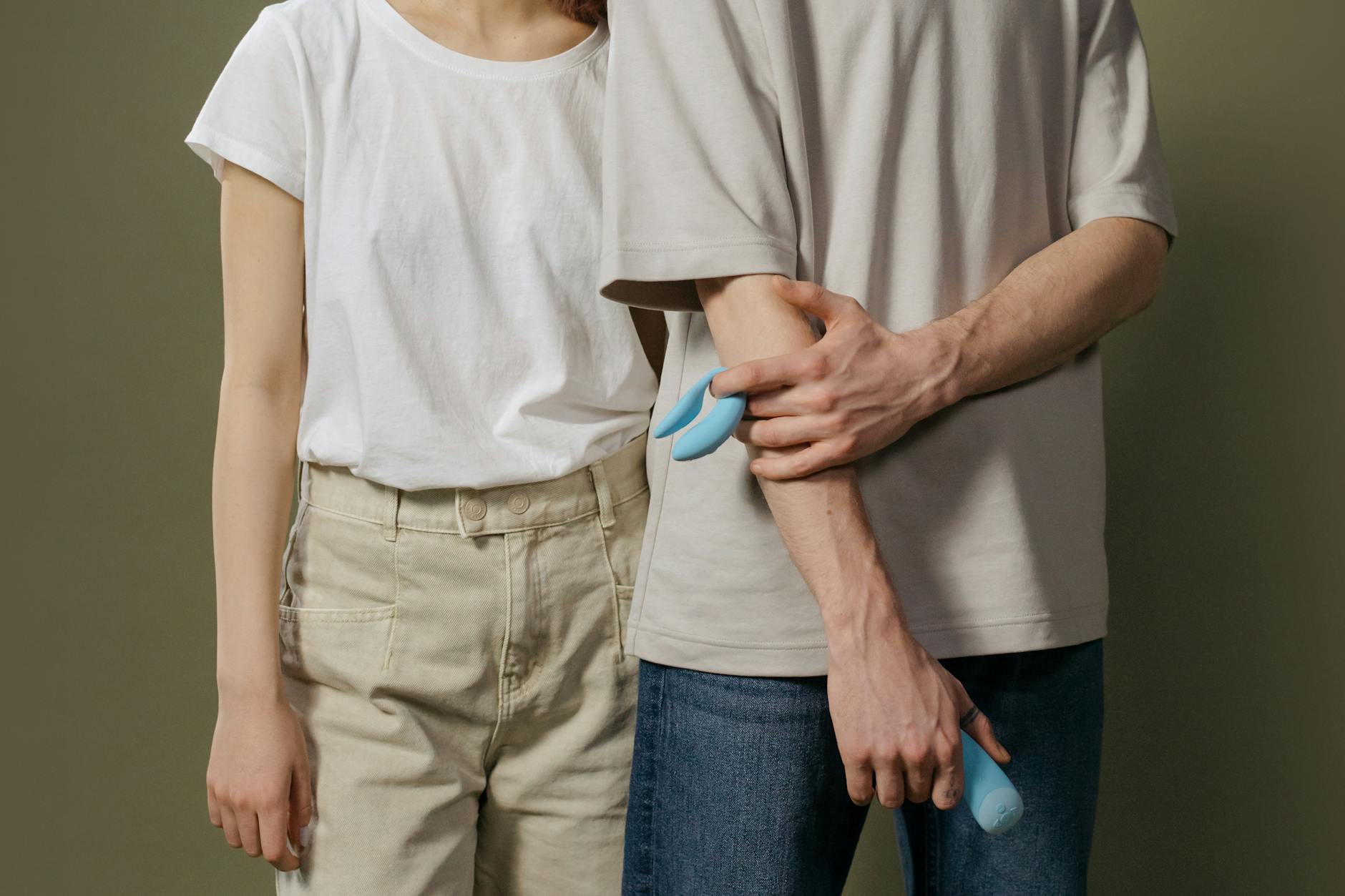 Hand holding a blue silicone vibrator against a purple background, symbolizing self-connection and reclaiming pleasure