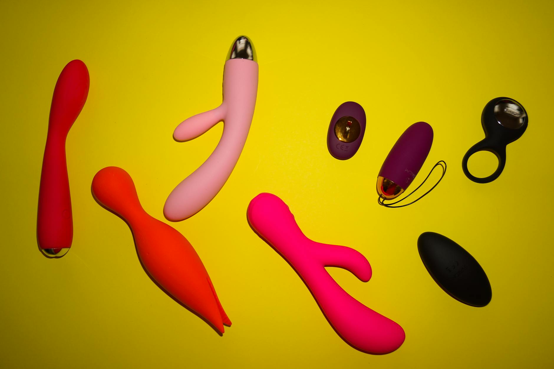 Various lemon vibrators and clitoral vibrators displayed on a bright yellow surface