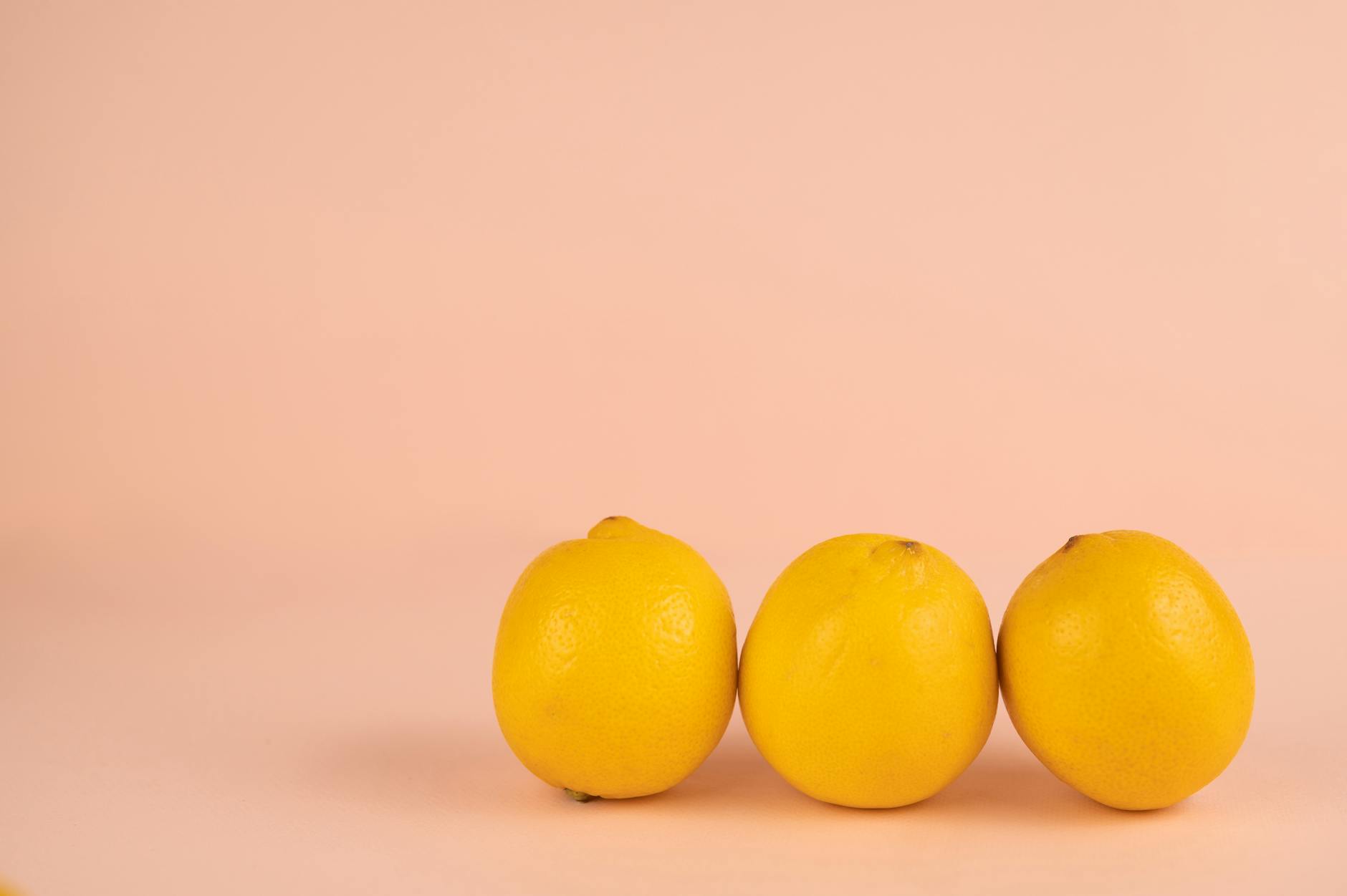 Yellow silicone vibrator surrounded by peeled bananas on yellow background