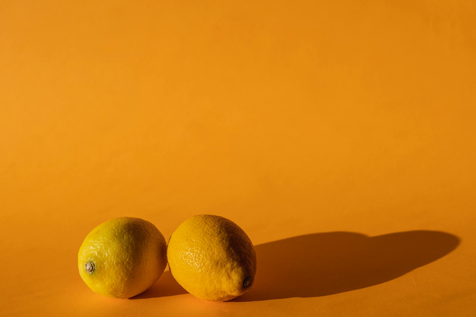 Ripe vivid lemons on a bright yellow background symbolizing freshness and vitality